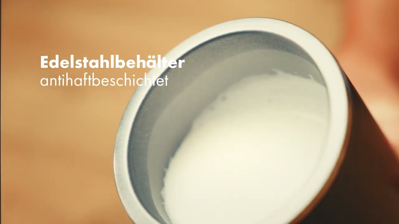 Stainless steel container with non-stick coating filled with milk, close-up shot