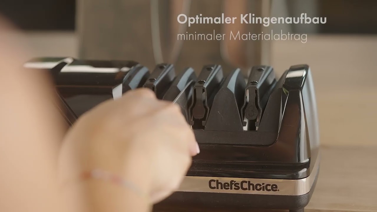 A hand inserts a knife into a sharpening tool for optimal blade build.
