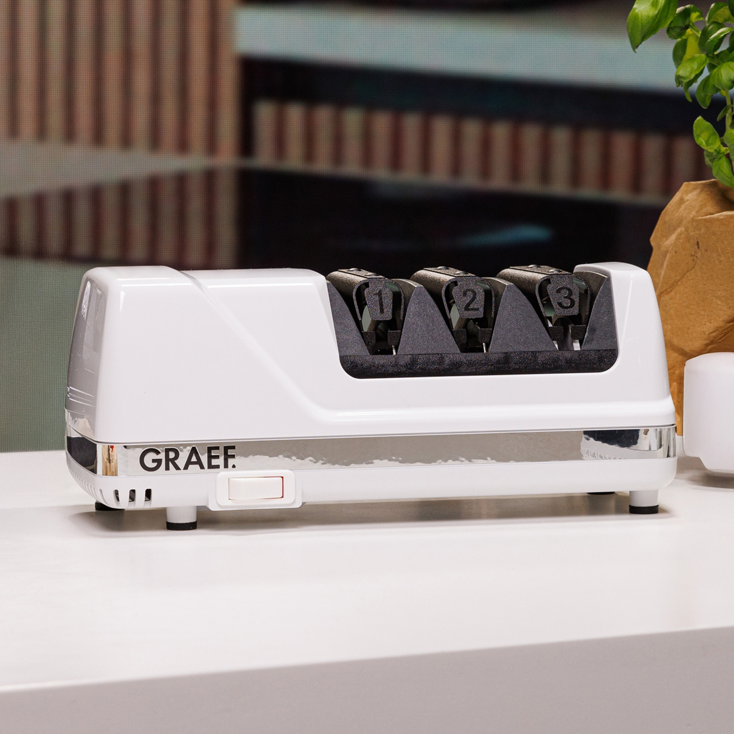 White electric knife sharpener with numbers 1, 2, and 3 on it.