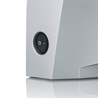 Close-up of a gray device with a round on-off switch, detail shot