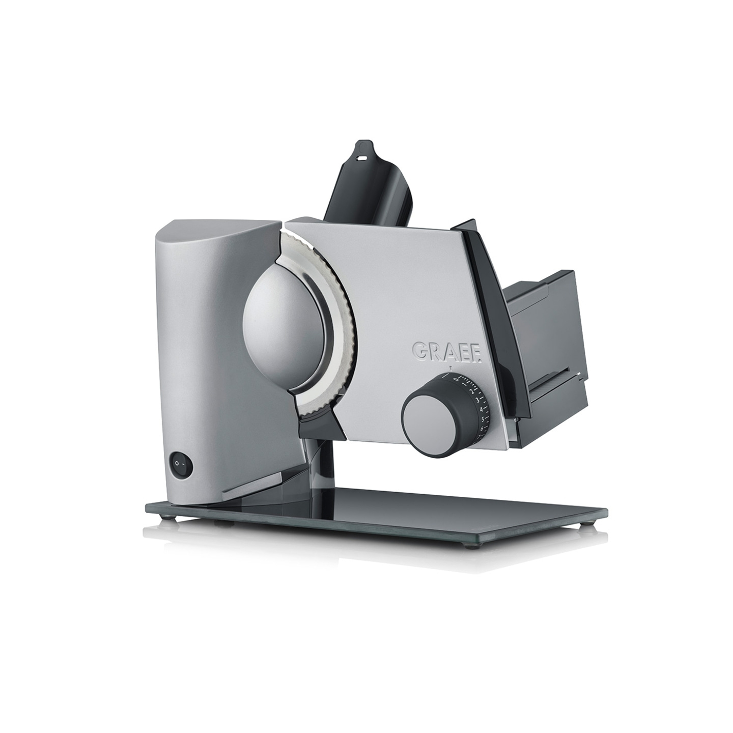 Silver Graef slicer with knob and blade, standing on a glass plate, kitchen appliance.