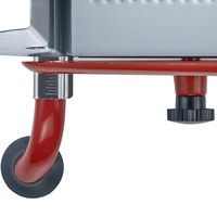 Close-up of a red metal frame with a black knob and a measurement scale