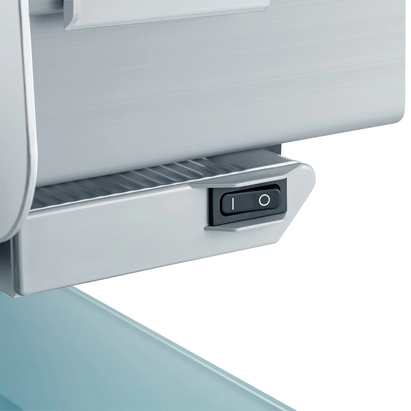 Close-up of an on-off switch on a device, resting on a blue surface.