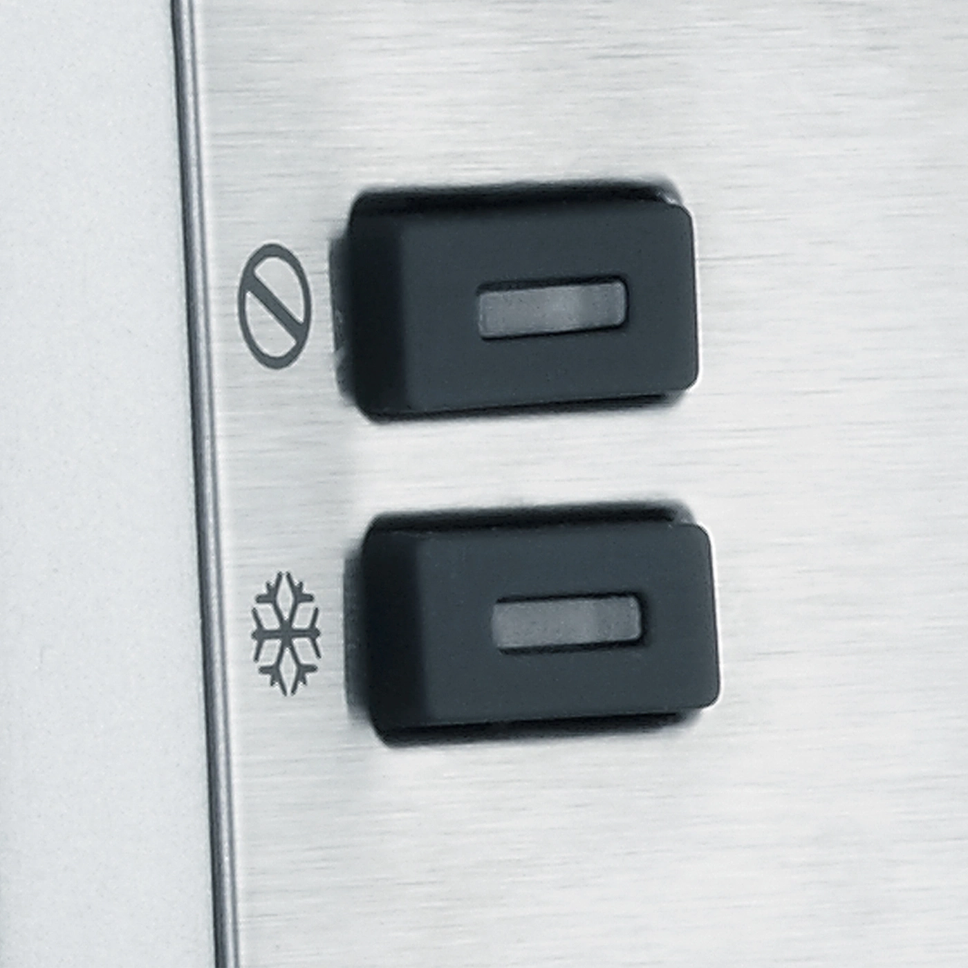 Two black buttons with symbols on a metallic surface, close-up shot.