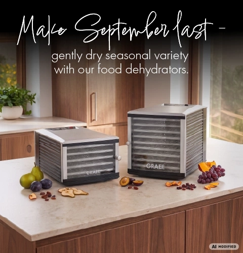 Food dehydrators on a countertop with fruits and vegetables
