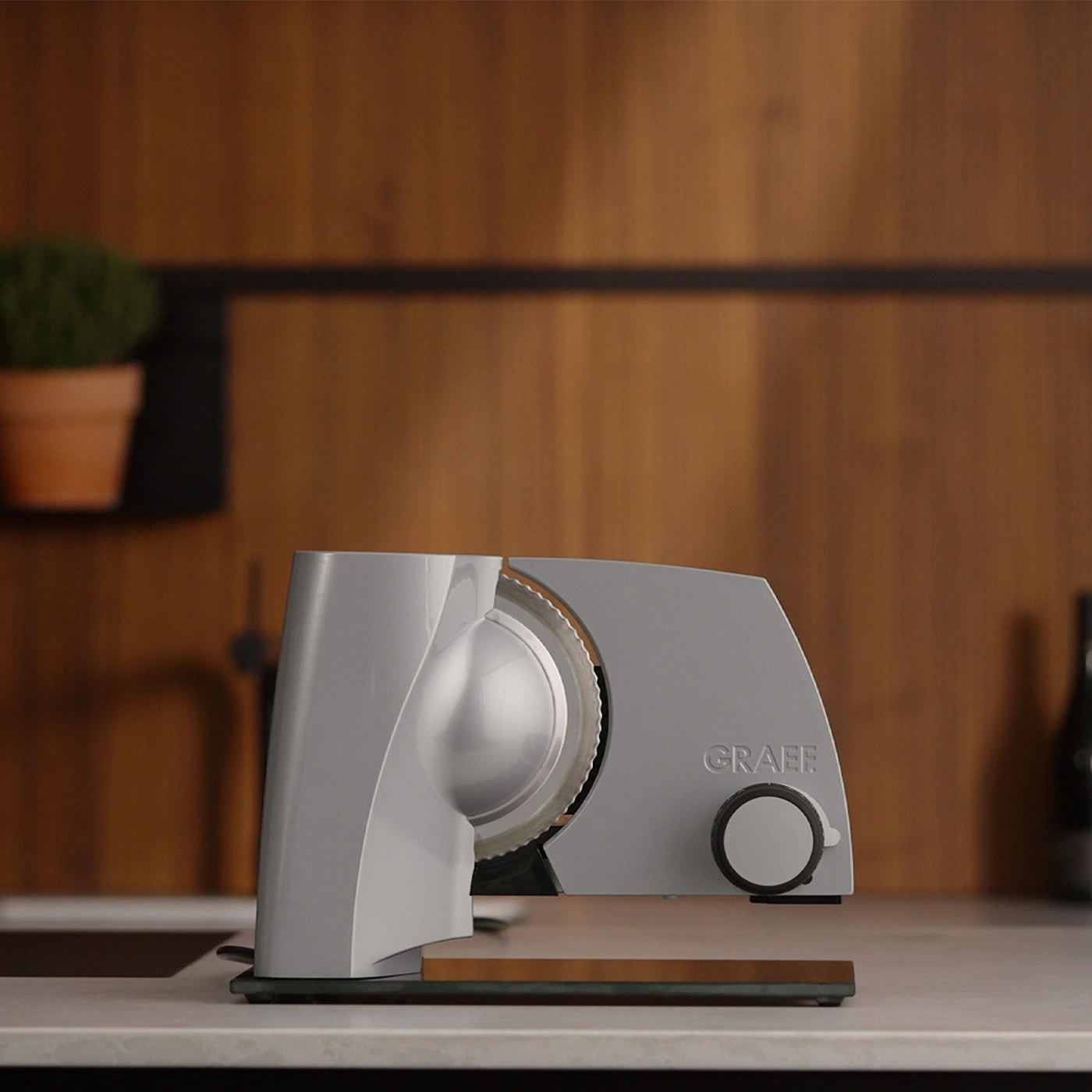 Graef slicer on countertop with wooden background
