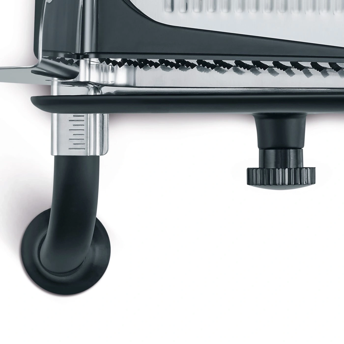 Close-up of a black kitchen appliance with an adjustment wheel and scale.
