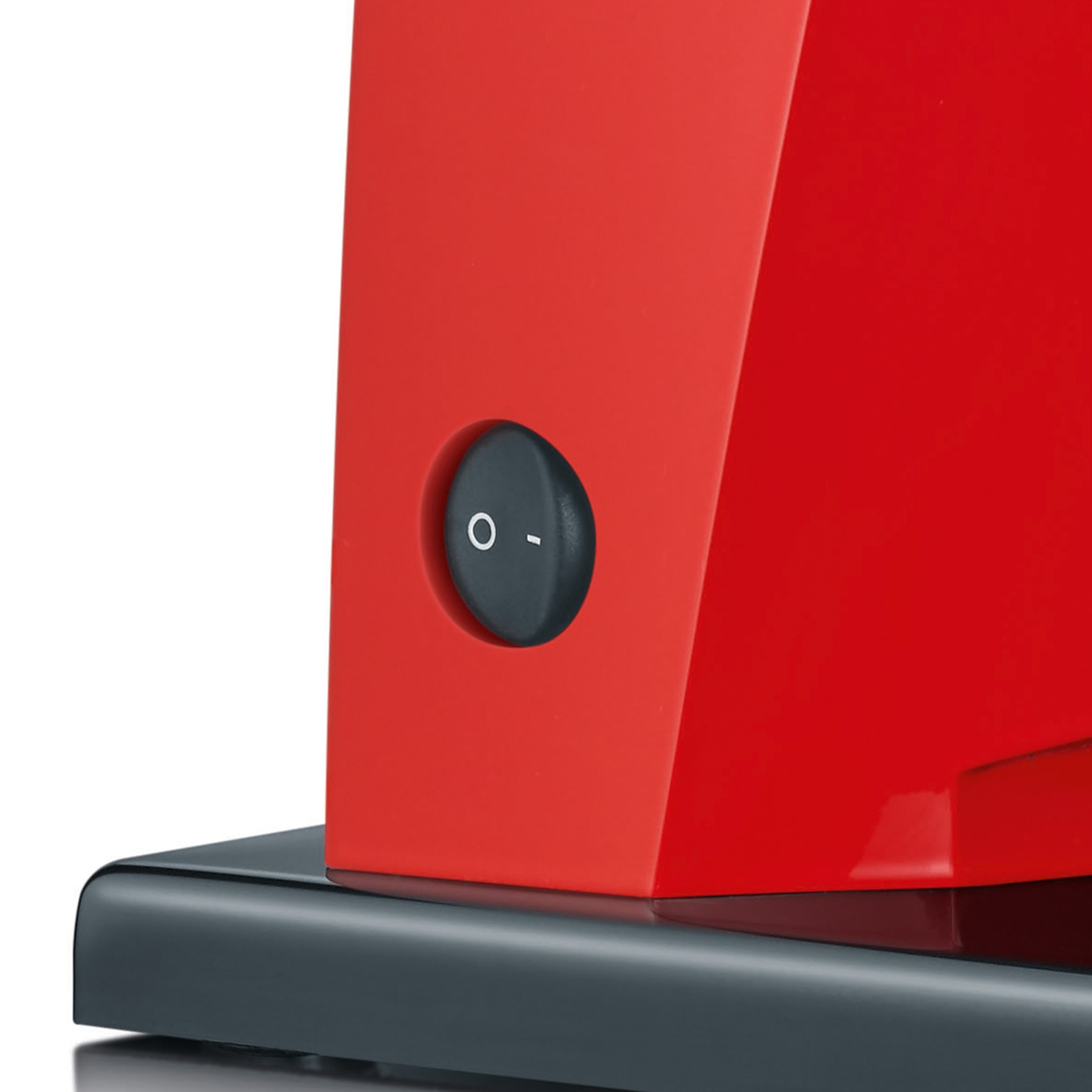 A red appliance with a black switch showing 'O' and '-' symbols.