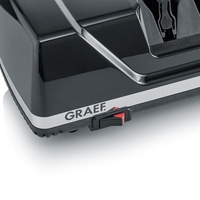 Close-up of a black device with GRAEF logo and red switch, shiny surface.