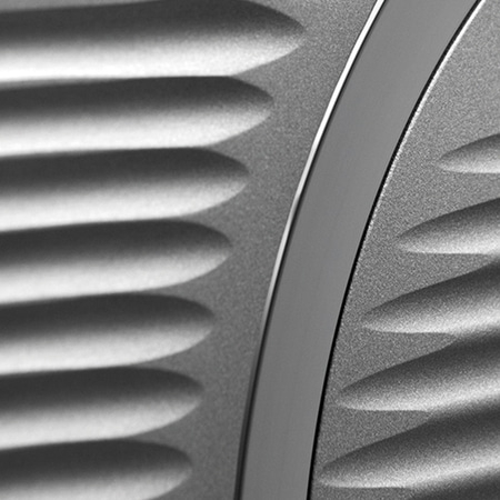Gray textured surface with a smooth dark stripe and a bright edge, close-up shot.