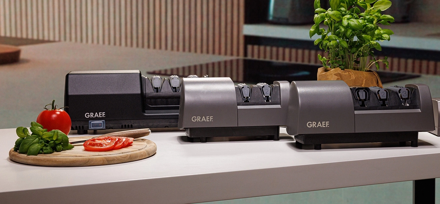 Three electric knife sharpeners by Graef with tomatoes and basil.