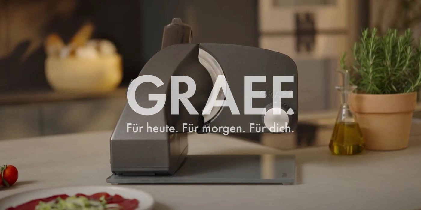 Graef slicer in a kitchen with herbs and oil, ready to slice.