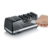 Graef knife sharpener, sharpening knives, hand holding knife, black