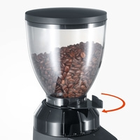 Coffee grinder with beans, black container, adjustable grind, arrow indicates direction