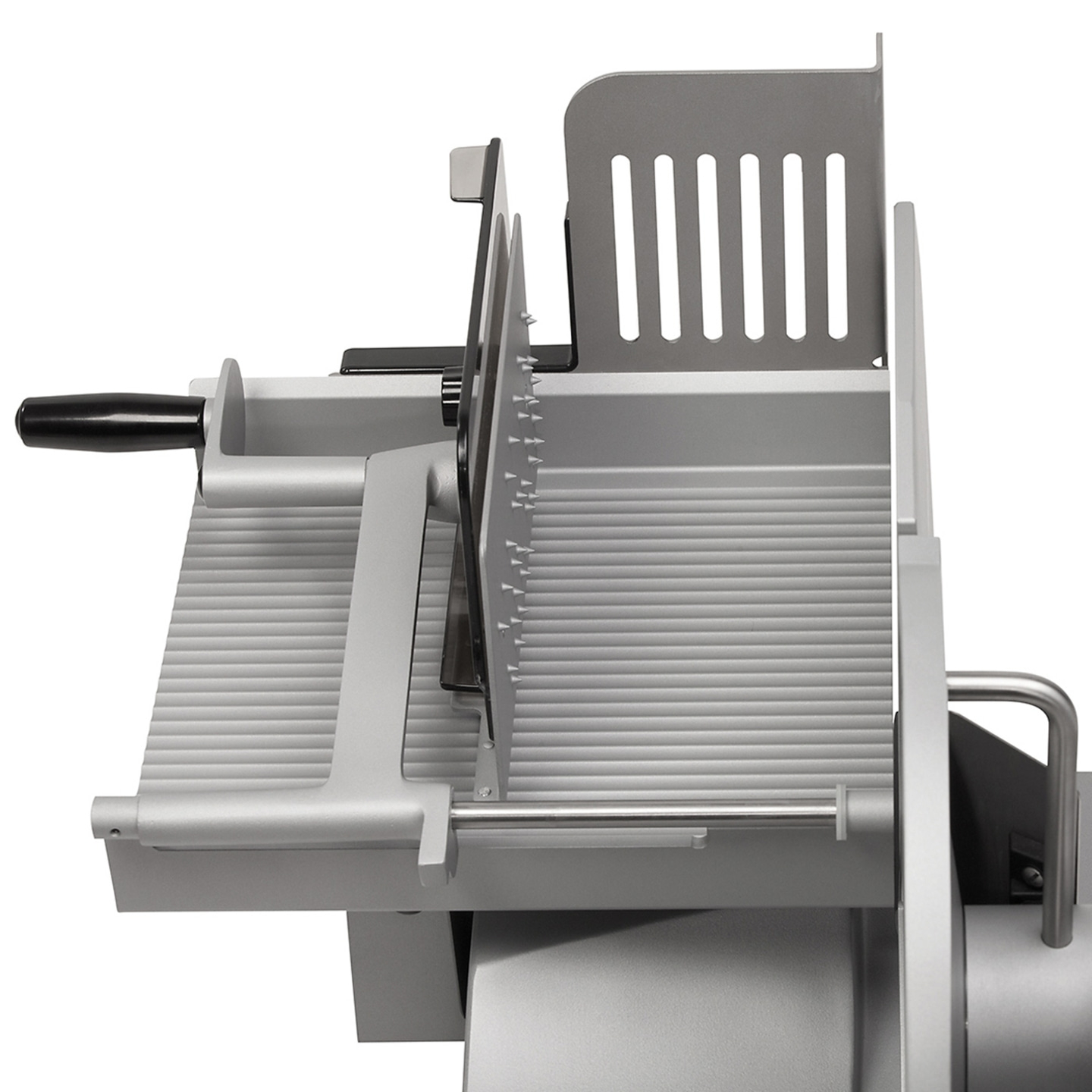 Close-up of a silver meat slicer with handle and blades, isolated