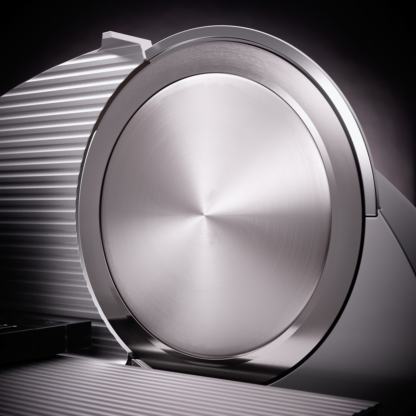 Close-up of a silver slicer with a shiny surface and shadows, modern design