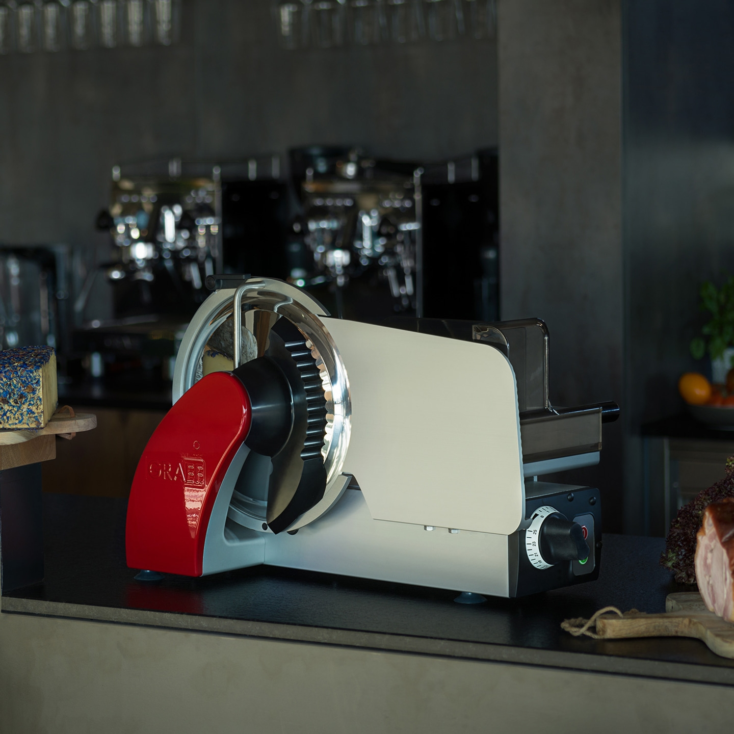 Graef slicer on a counter with cheese and meat in the background