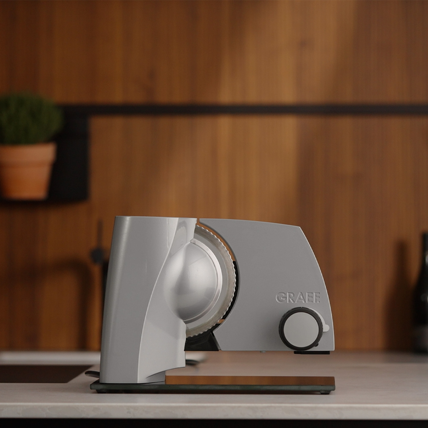 Graef slicer on countertop with wooden background