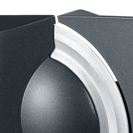 Close-up of a black object with a silver curved blade and intricate details