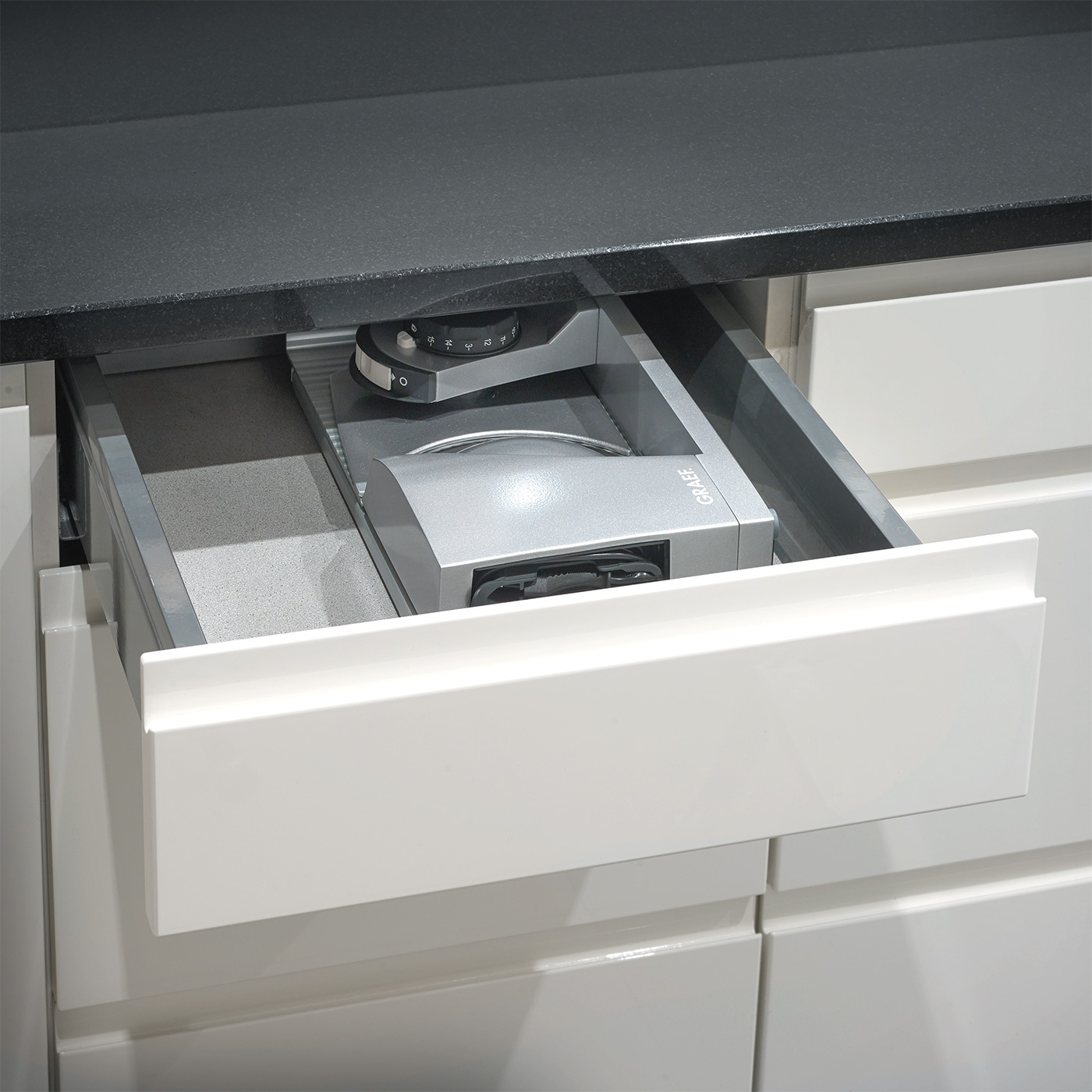 Kitchen drawer with integrated appliance, gray and white, close-up, modern design
