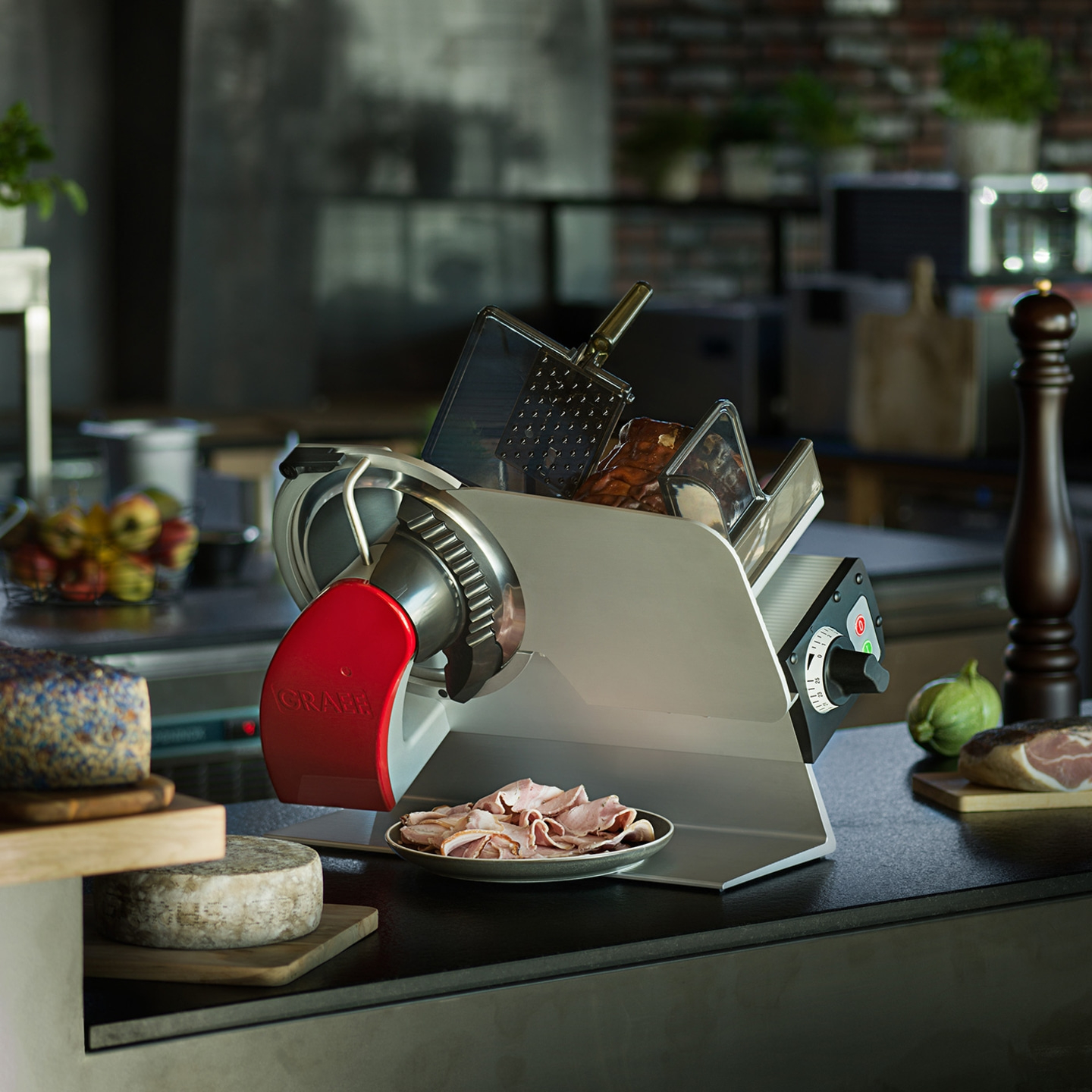 Meat slicer with cheese and meat on a table in a kitchen setting