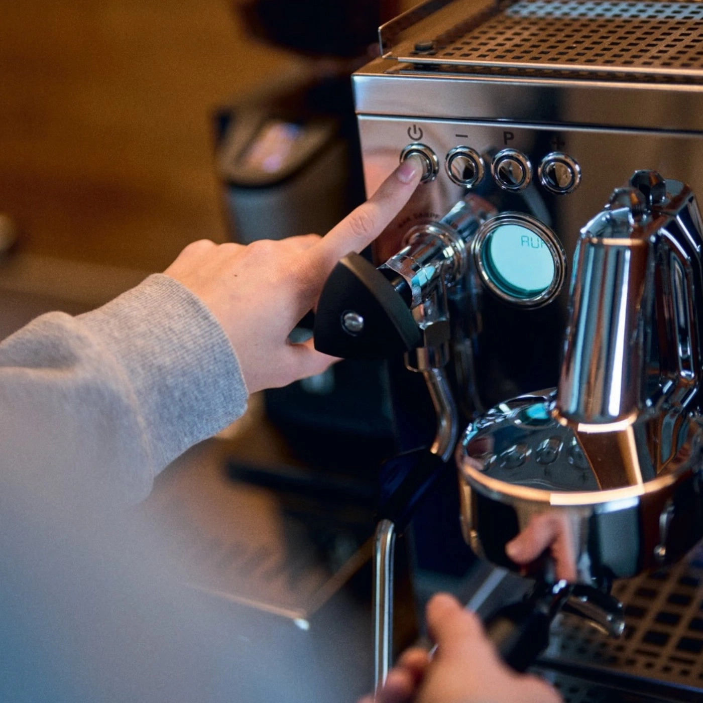 Persona che preme il pulsante sulla macchina del caffè, primo piano, mani, macchina, avvio