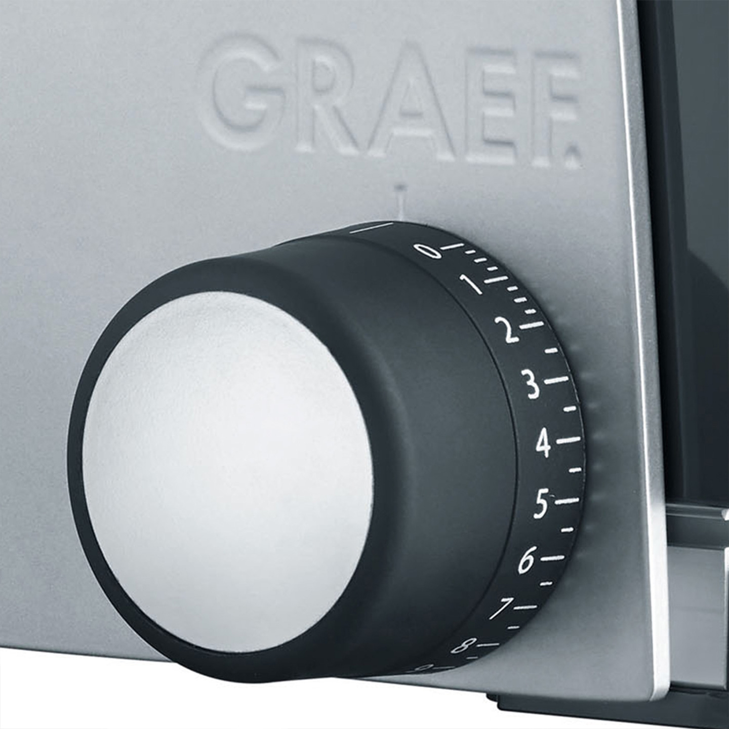 Close-up of a black dial with numbers on a gray background, Graef logo visible.
