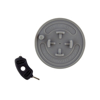 Gray disc with text and black cleaning pin for coffee machine, top view.