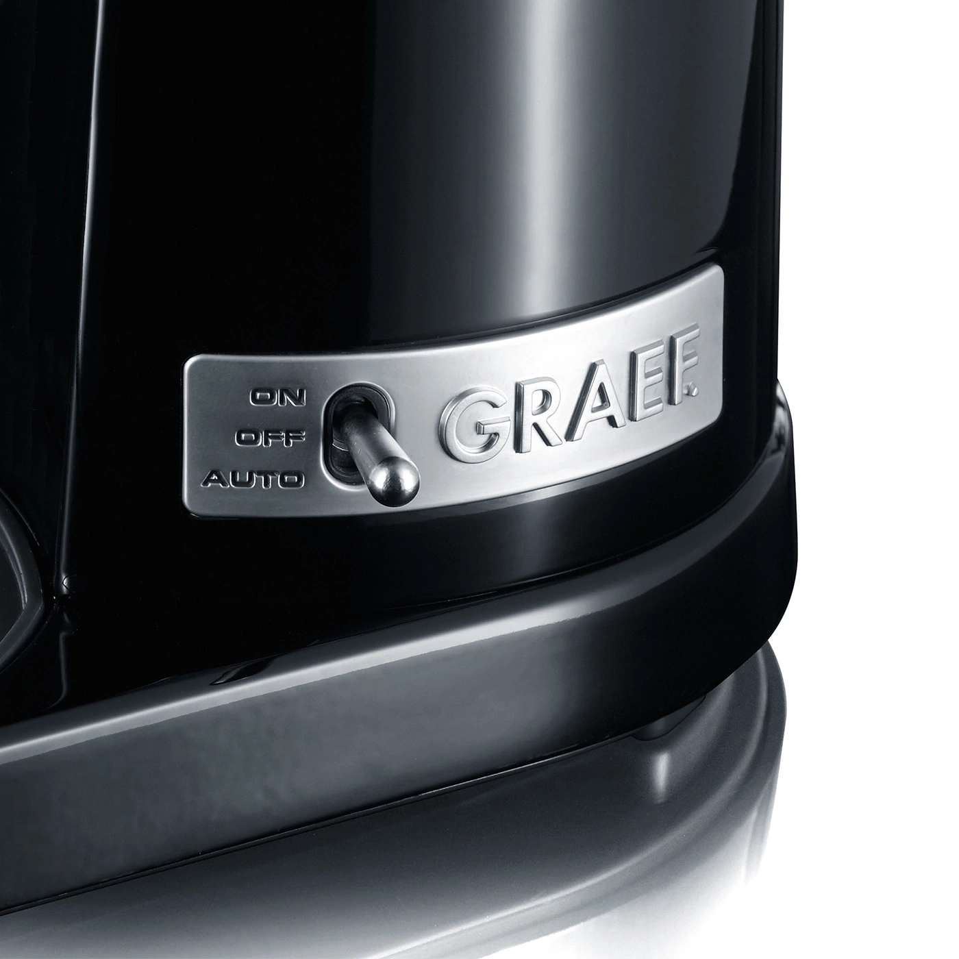 Close-up of a switch with ON, OFF, AUTO options and the GRAEF brand name on a black appliance.