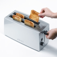 Toaster with toast, hand removing toast, silver appliance, GRAEF brand name.