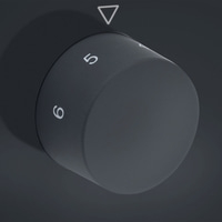 Rotary knob with numbers 5 and 6, dark background, triangle mark, gray