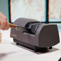 Graef knife sharpener, knife, hand, sharpening, kitchen, tool, gray, wooden handle, detail