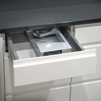 Kitchen drawer with integrated appliance, gray and white, close-up, modern design