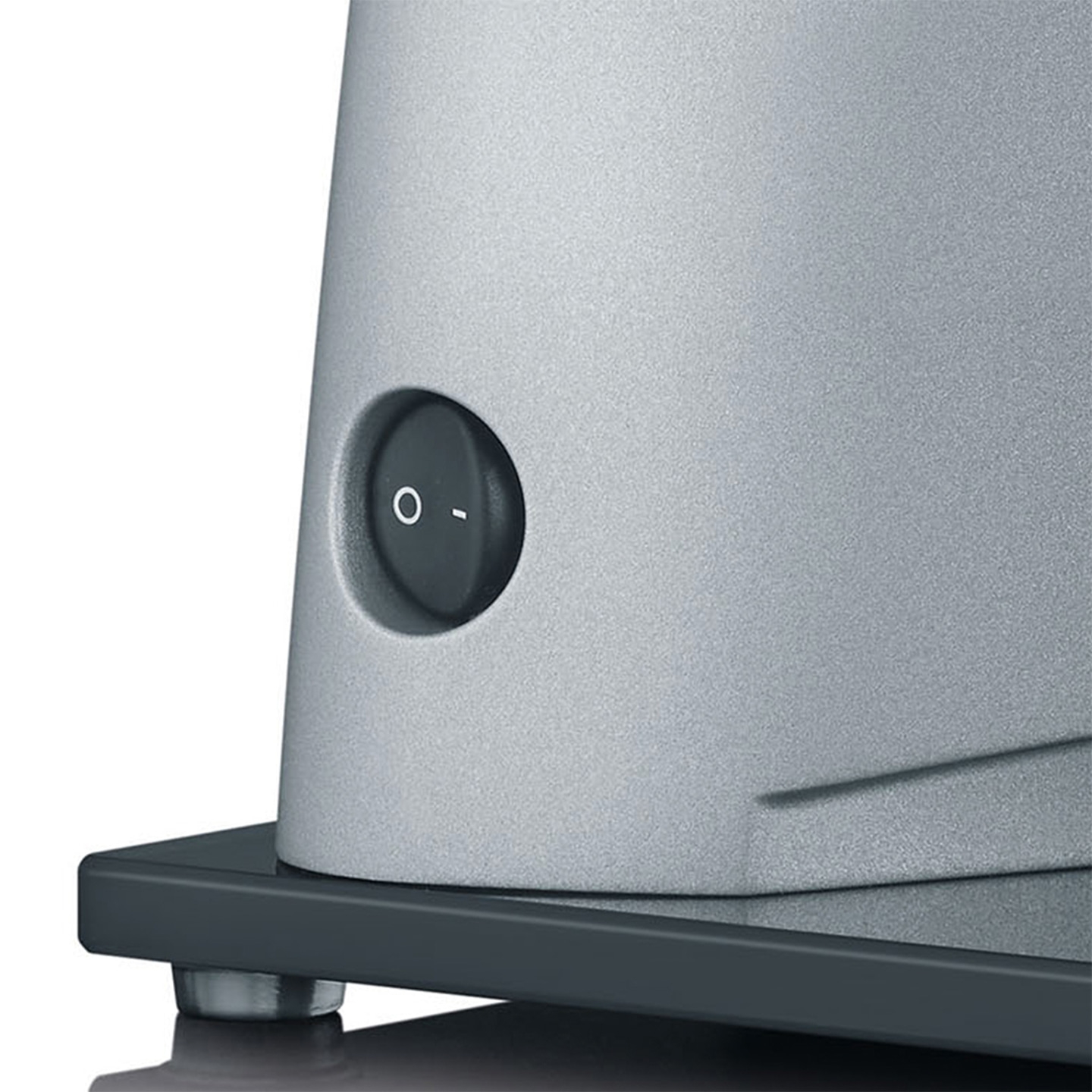Close-up of a gray appliance with an on/off switch and dark base.