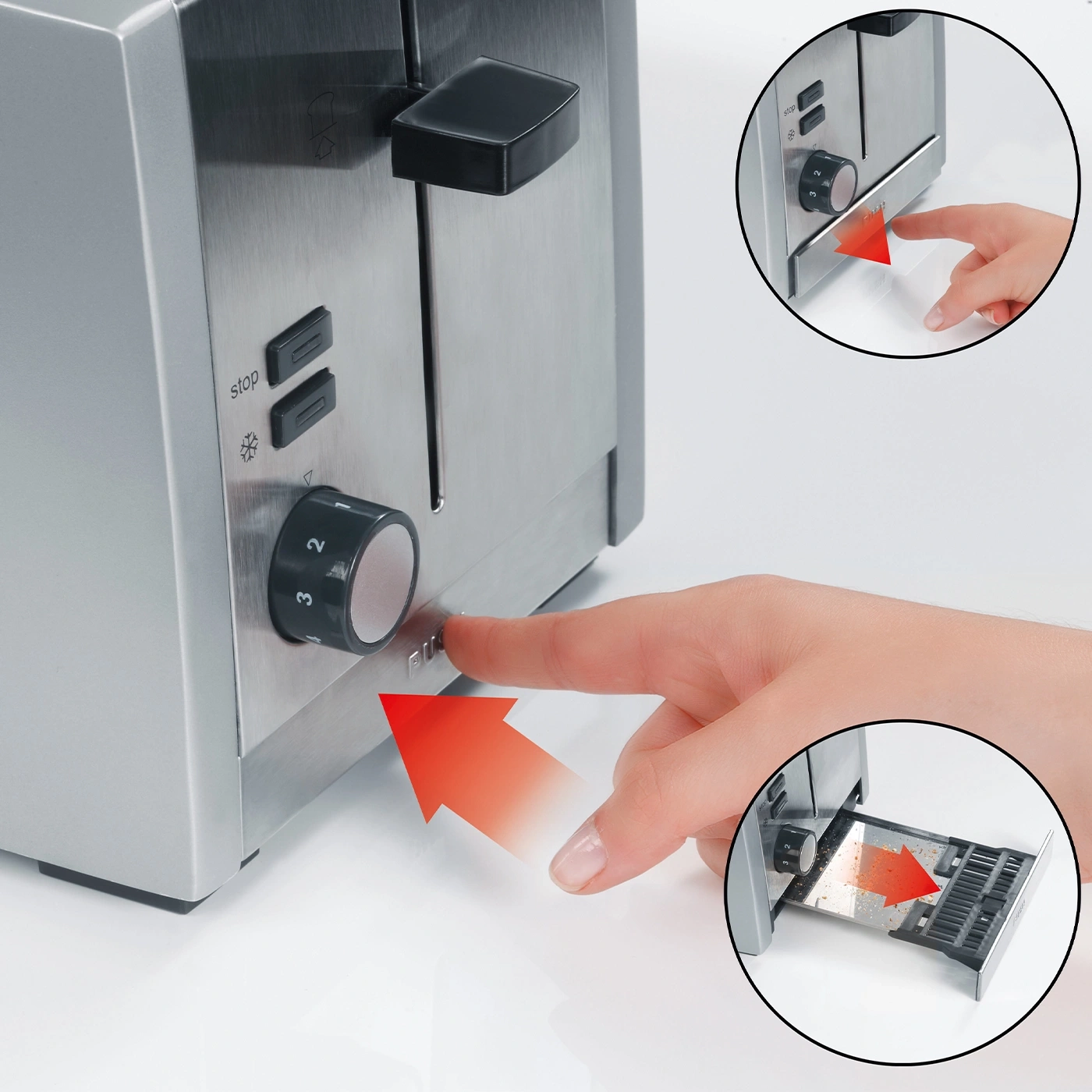 A finger presses a knob to operate the toaster.