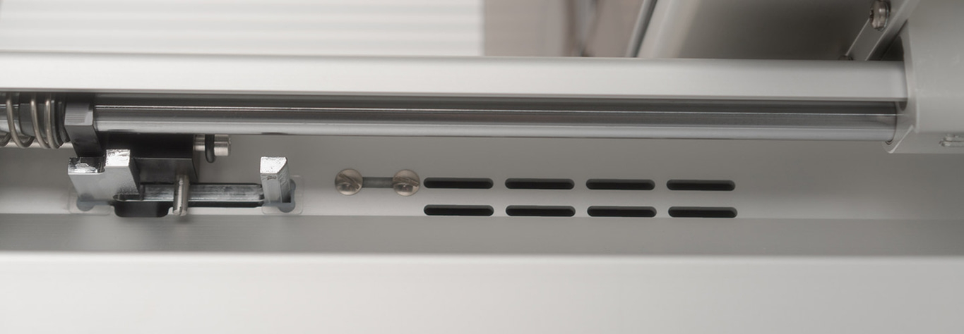 Close-up of metal rods and structures with ventilation slots and screws