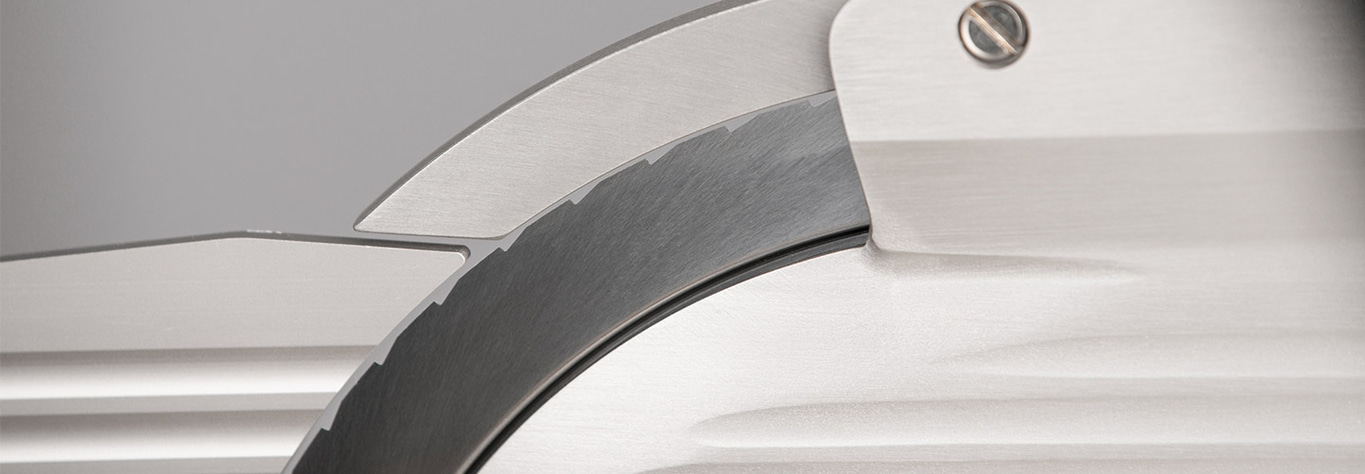 Close-up of a silver circular saw with teeth and intricate details.