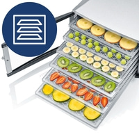 Food dehydrator with fruits: apples, grapes, bananas, kiwi, strawberries, mango.