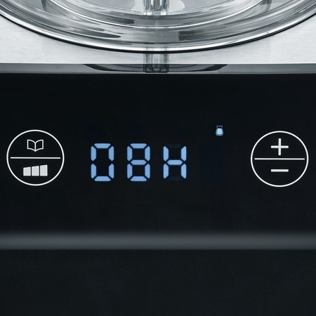 Close-up of control panel with display and symbols for operation and settings.