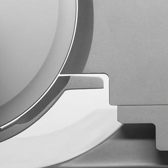 Grayscale close-up of a metallic object with rounded edges and shadows, minimalist design