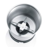 Coffee grinder from above. Stainless steel container with blades and black base.