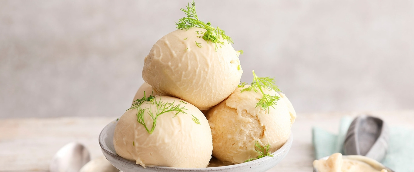 Close-up of ice cream scoops with dill on a plate, delicious