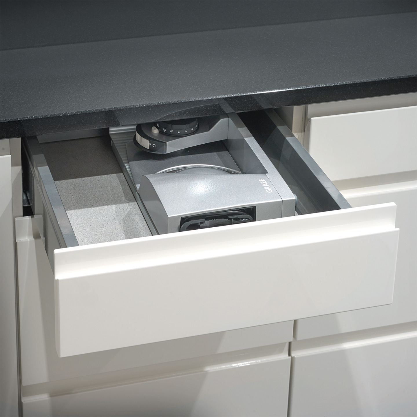 Kitchen drawer with integrated appliance, gray and white, close-up, modern design