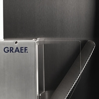 Graef logo on metal surface with serrated knife and dark background