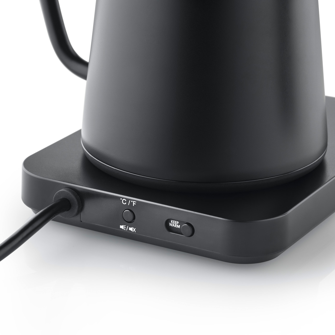 Black kettle with controls and power cord on a white surface, close-up shot.