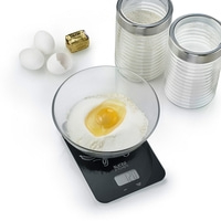 Baking ingredients: eggs, butter, flour, sugar, scale, bowl, jars, and an egg.
