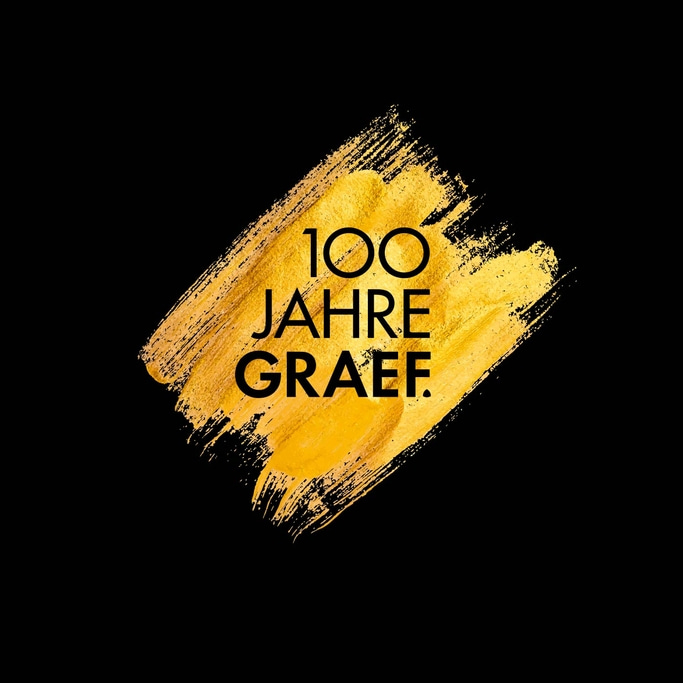 Goldener Pinselstrich mit Text: 100 Jahre Graef auf schwarzem Hintergrund.