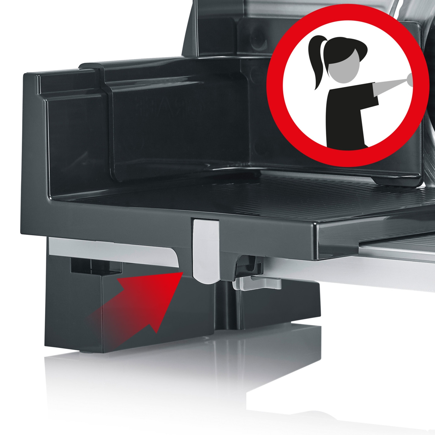 Food slicer with red arrow and warning symbol for safety instructions