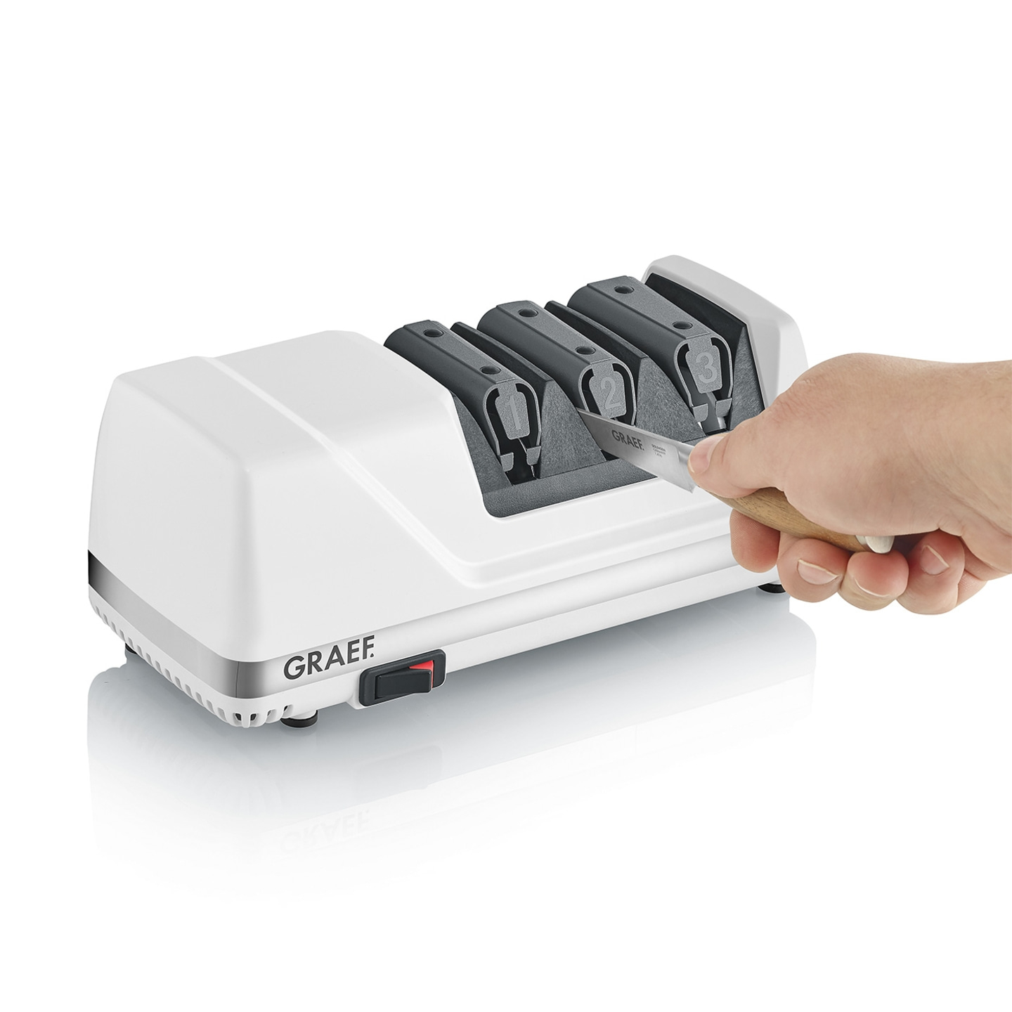 Knife being sharpened with electric knife sharpener. Graef logo and knife.