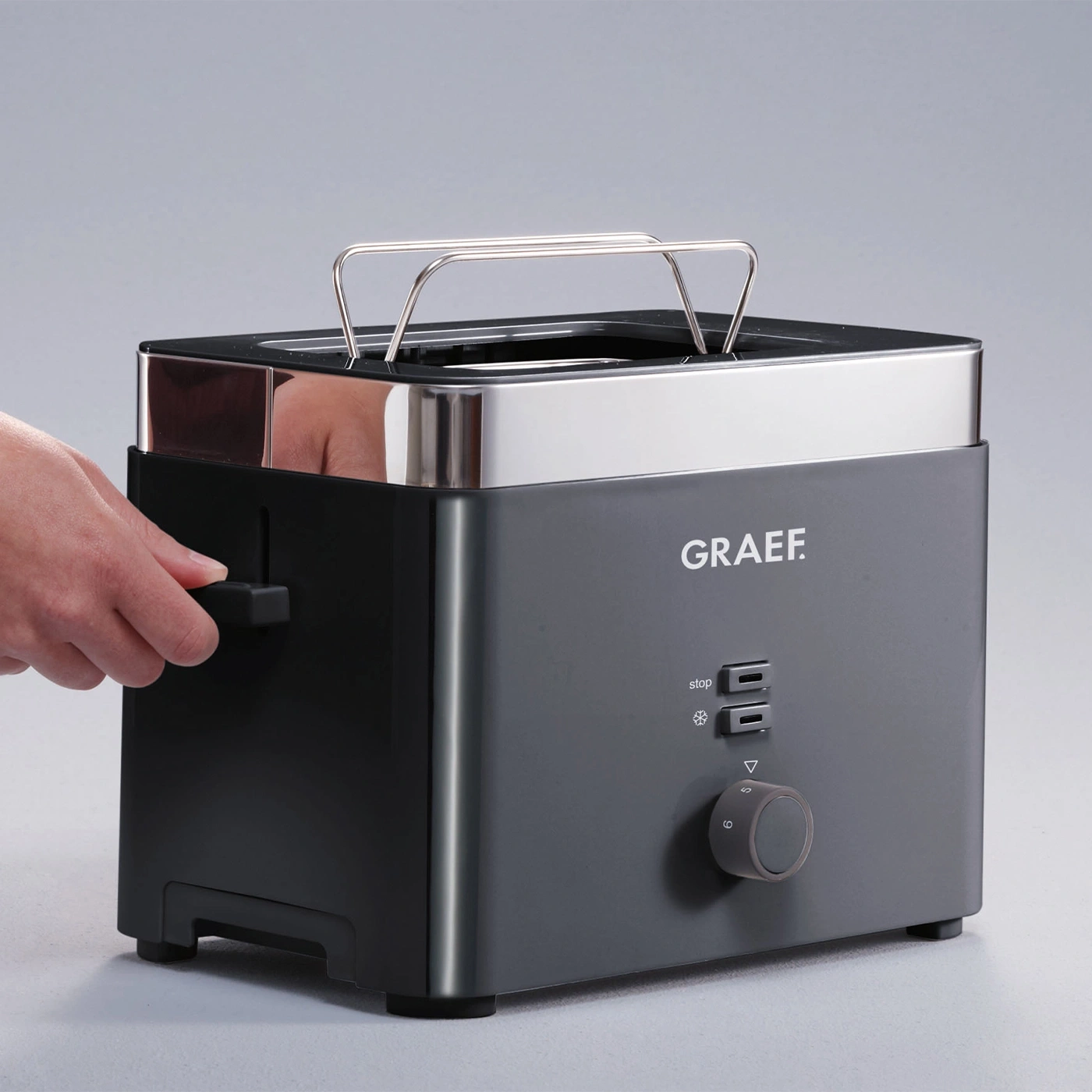 A modern Graef toaster with chrome accents and a dial for browning level.